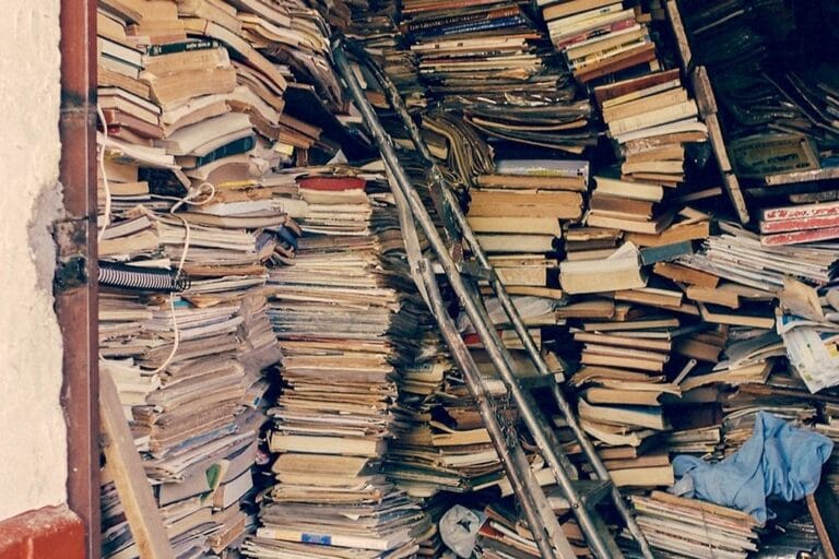 Piles of books in a garage